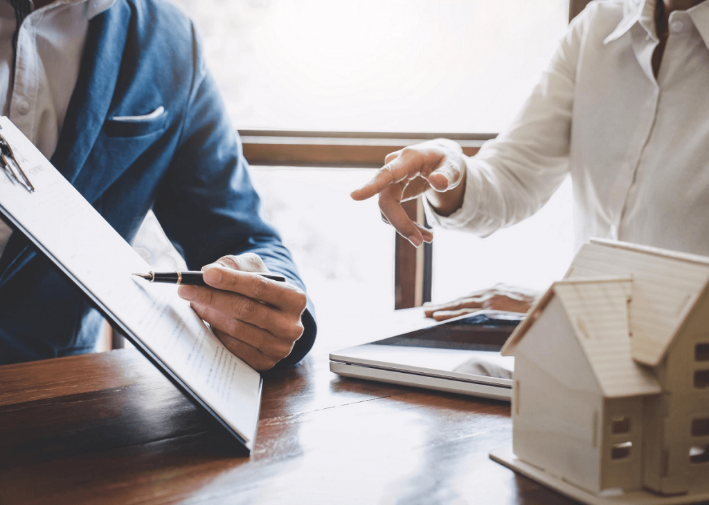 Two people discussing paperwork